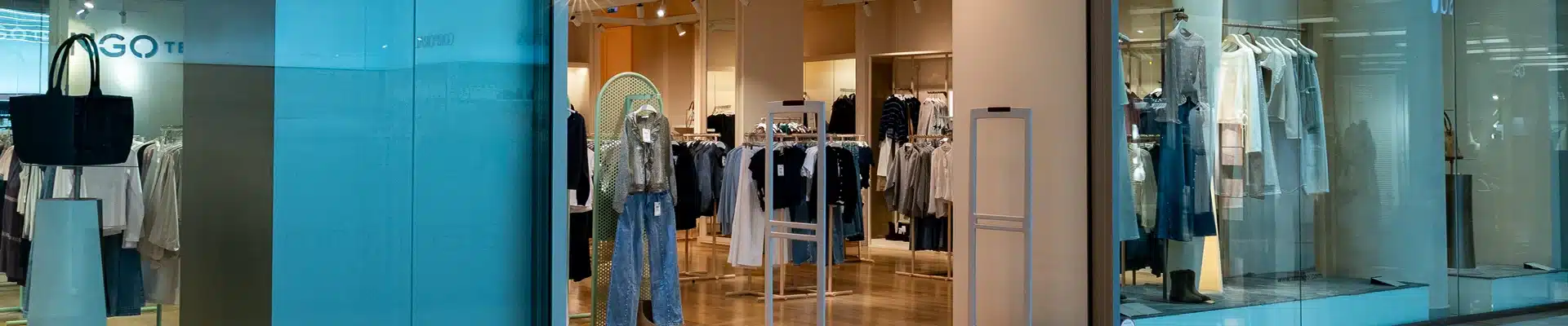 Escaparate de la tienda de moda Mango Teen en el centro comercial Aragonia, con maniquíes vestidos, percheros de ropa juvenil y vaqueros